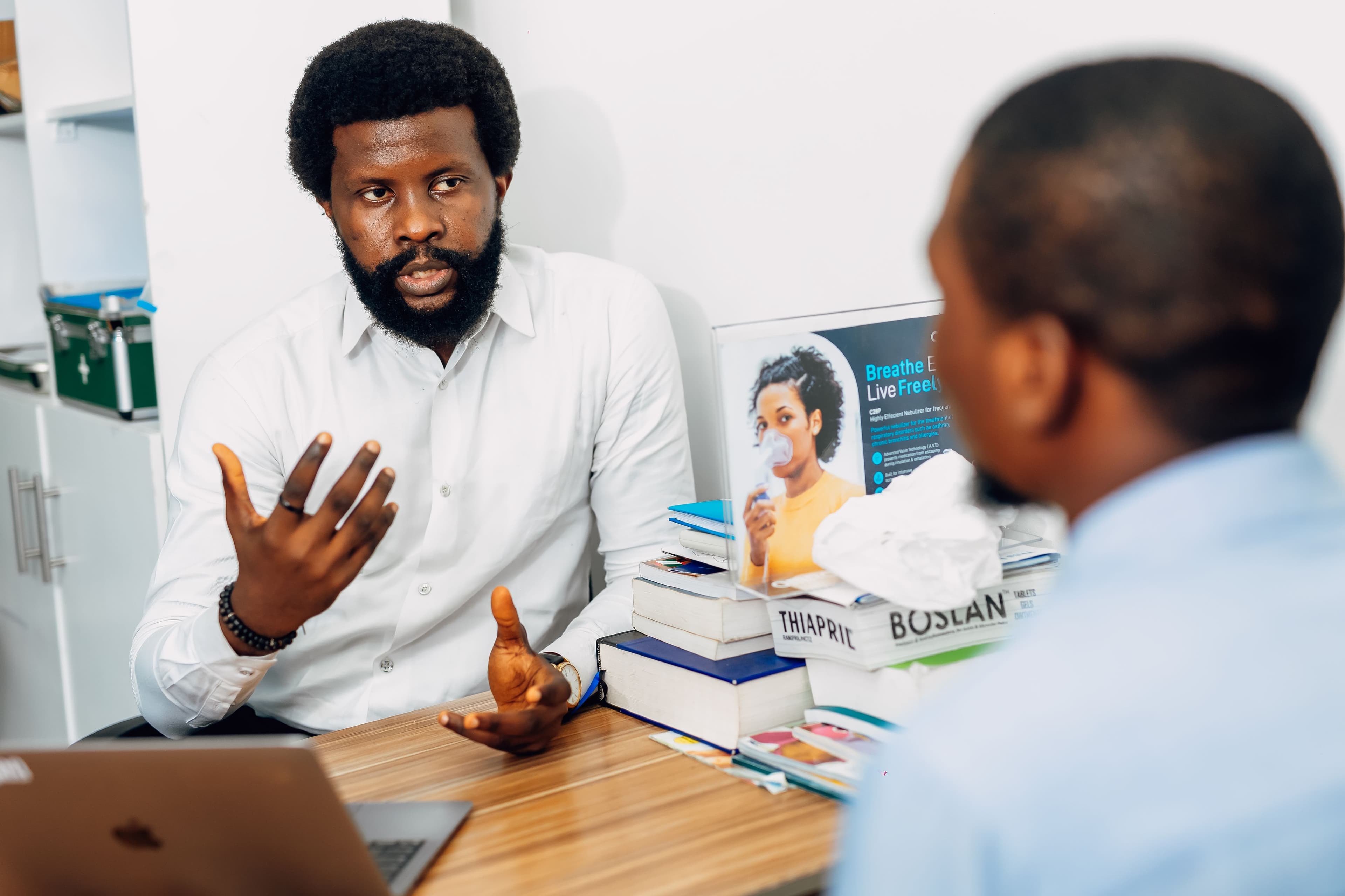 A healthcare professional speaking with a patient during a consultation. Demonstration photography, not a photograph of Beulah Group Hospital, its staff, or its facilities.